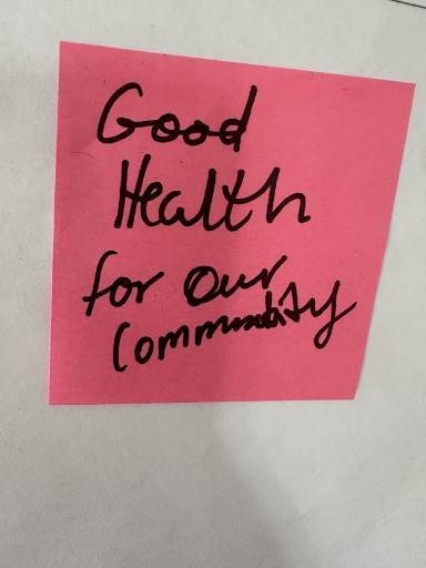 Handwritten pink sticky note: Good health for our community.