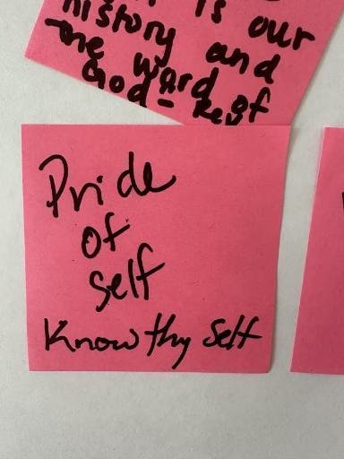 Handwritten pink sticky notes about history and pride of self.
